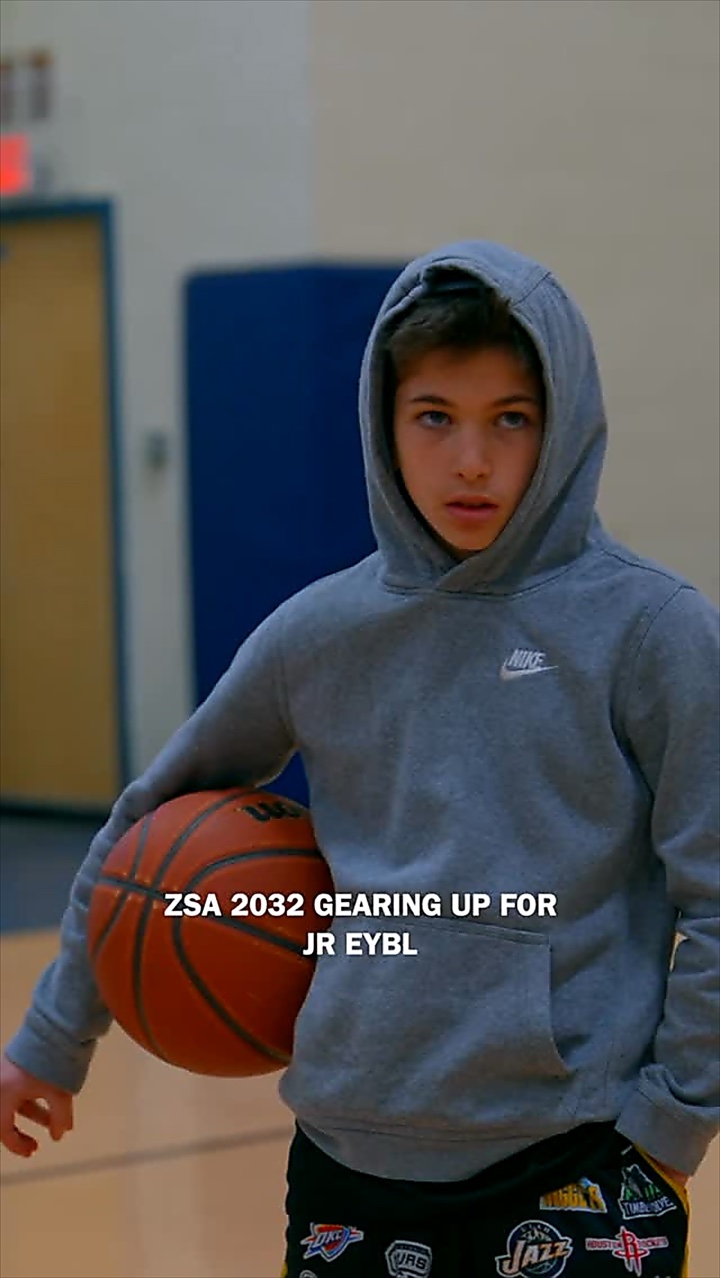 Reel: a young athlete in a grey hoodie holding a basketball, gearing up for JR EYBL