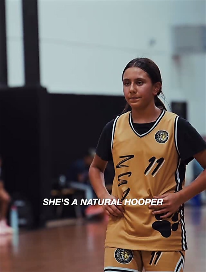 Reel: a young player in a gold ZSA jersey — “She’s a natural hooper”
