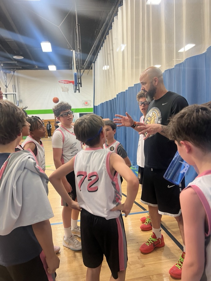 Coach speaking to a team huddle during a game